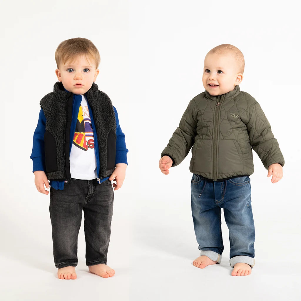A Baby Boy and a Baby Girls, deep in the woods, wearing stylish outfits.