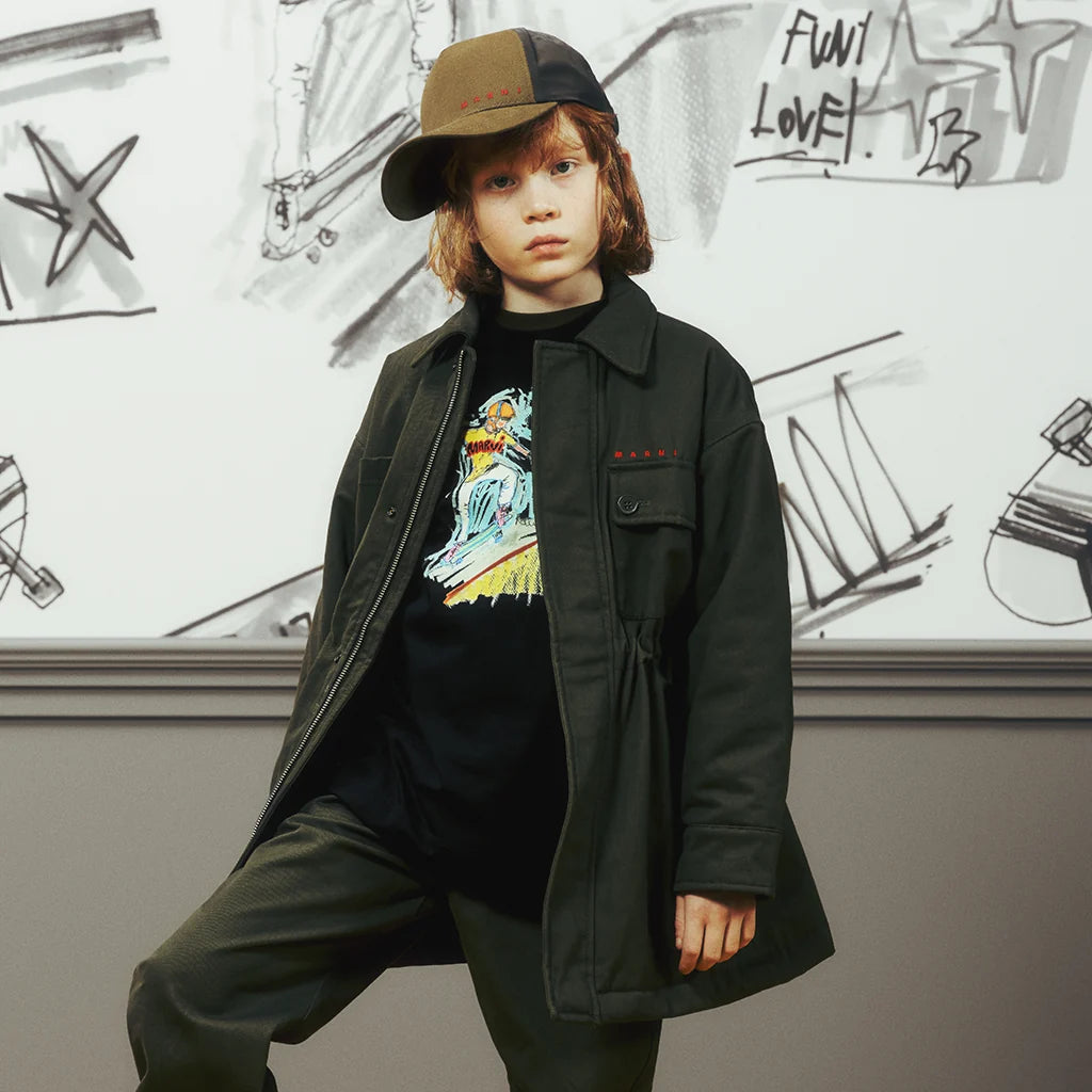 A boy wearing a casual fall outfit by Marni.